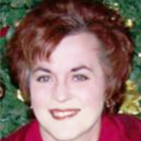 Headshot of a redheaded businesswoman smiling