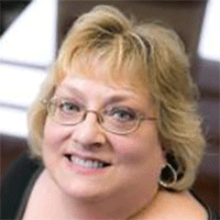 Headshot of a Blonde businesswoman smiling