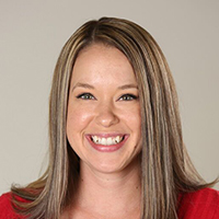 Woman in casual attire smiling.