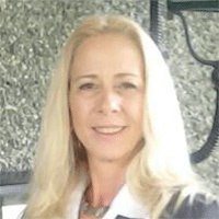 Headshot of a blonde businesswoman smiling