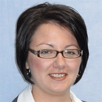 Headshot of a dark-haired businesswoman smiling