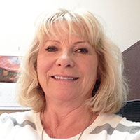 Headshot of a blonde businesswoman smiling