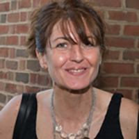 Headshot of a dark-haired businesswoman smiling