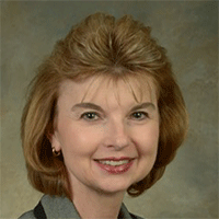 Headshot of a light-haired businesswoman smiling
