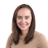 Headshot of a dark-haired businesswoman smiling