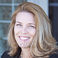 Headshot of a light-haired businesswoman smiling