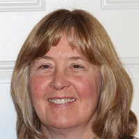 Headshot of a light-haired businesswoman smiling