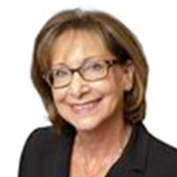 Headshot of a brown haired businesswoman smiling