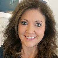 Headshot of a brown haired businesswoman smiling