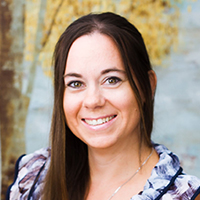 Woman in casual attire smiling.