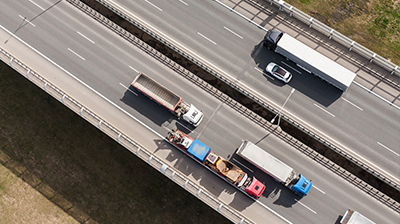 Birds eye view of highway roads and vehicles.