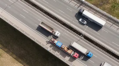 Birds eye view of highway roads and vehicles.
