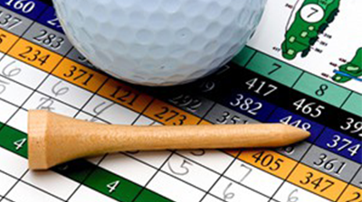 Golf-ball and tee laying on a golf scorecard