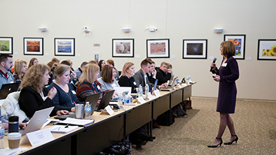 Speaker and attendees at Applied Systems Implementation Program event in University Park, Illinois.