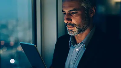 Man using a tablet at night