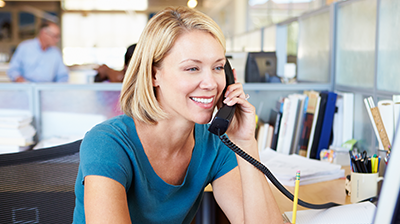 Young woman on the phone in her office