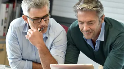 Two businessmen using a tablet