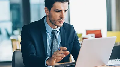 A businessman working on a laptop computer
