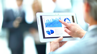 Man reviewing metrics on a tablet