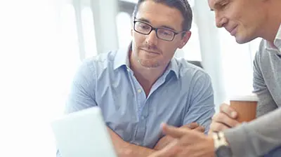 Two businessmen working on a laptop