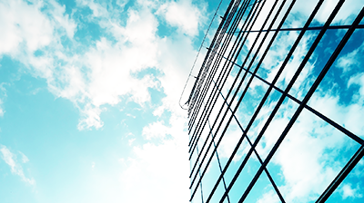 Blue skys reflecting on a glass building