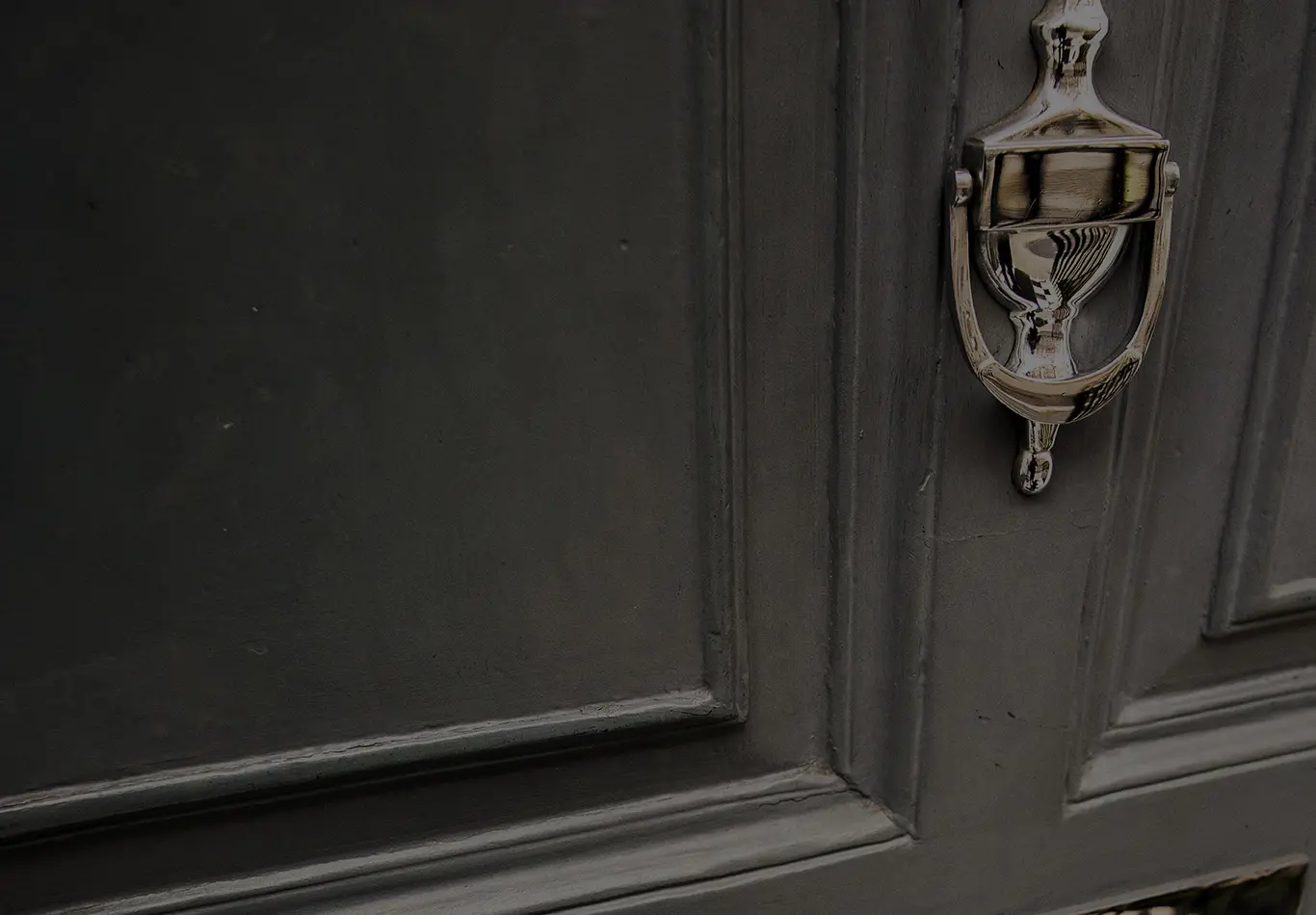 A close up of a door with a brass colored knob