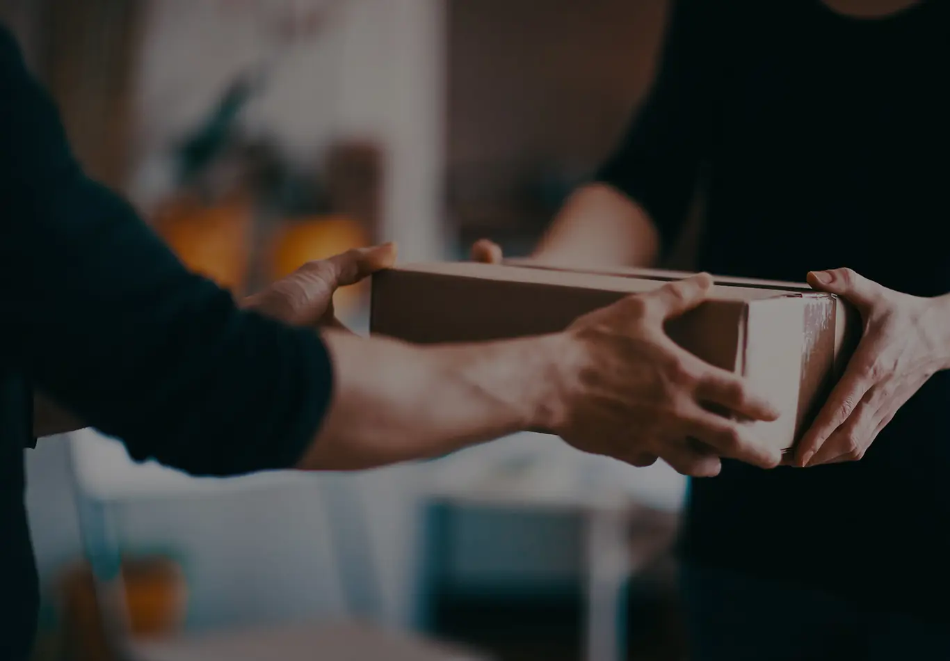 One person is handing a package to another person
