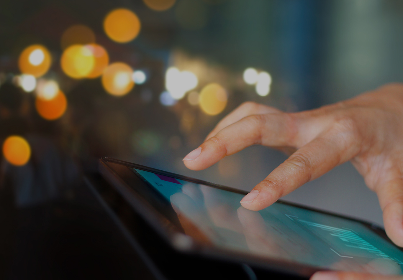 Close up of a hand using a tablet.