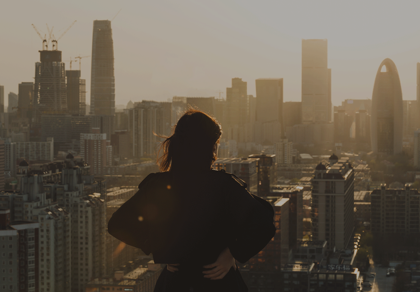 Woman looking at the skyline of a metropolitan city.
