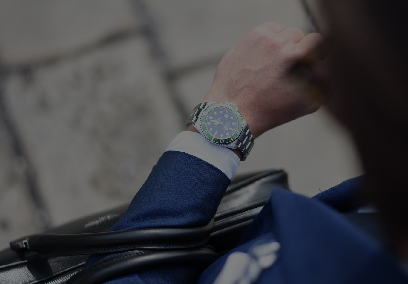 A watch on a person's wrist is in focus in the picture