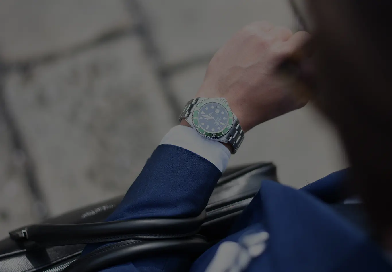 A watch on a person's wrist is in focus in the picture