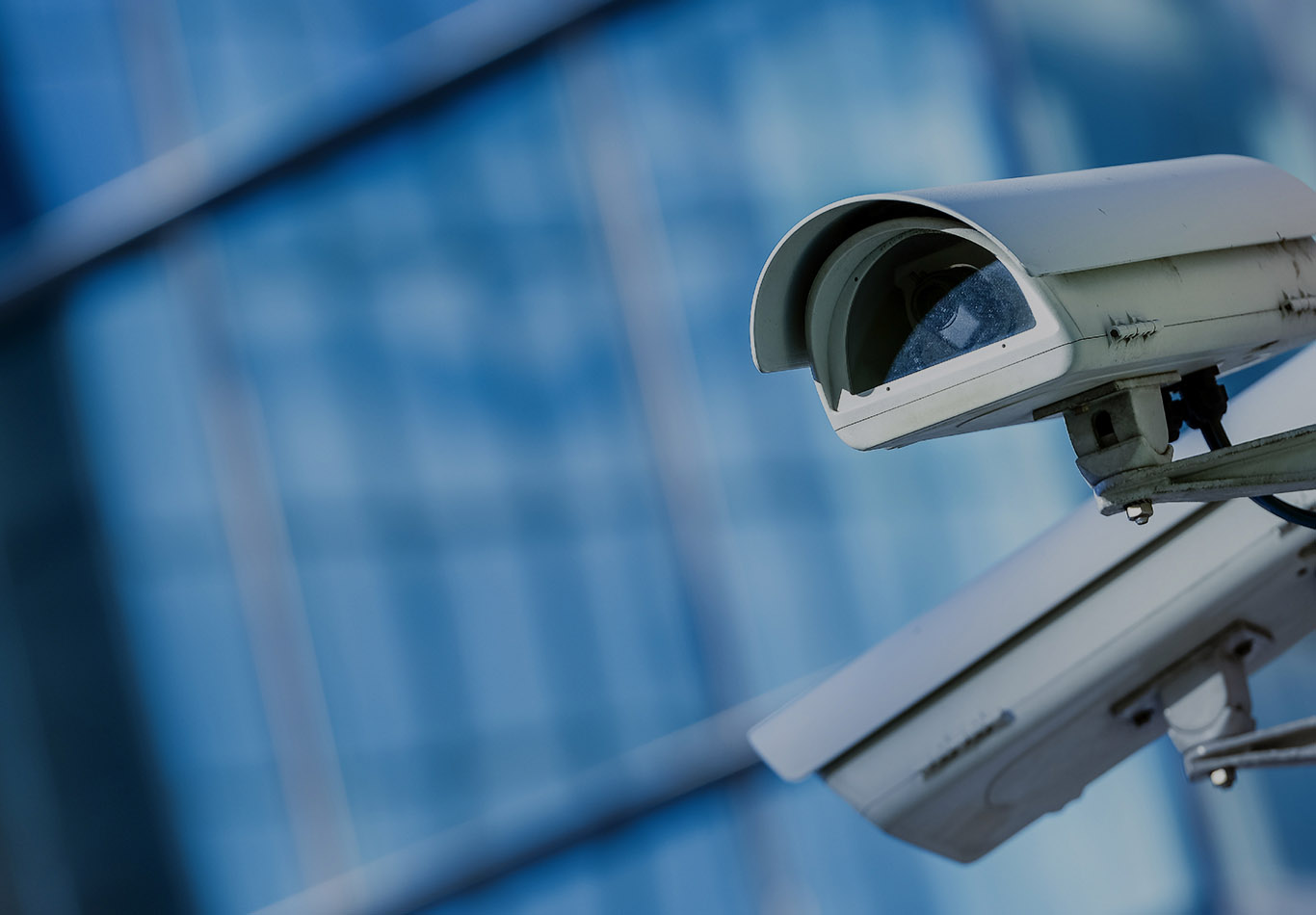 Two surveillance cameras are pointing in different directions