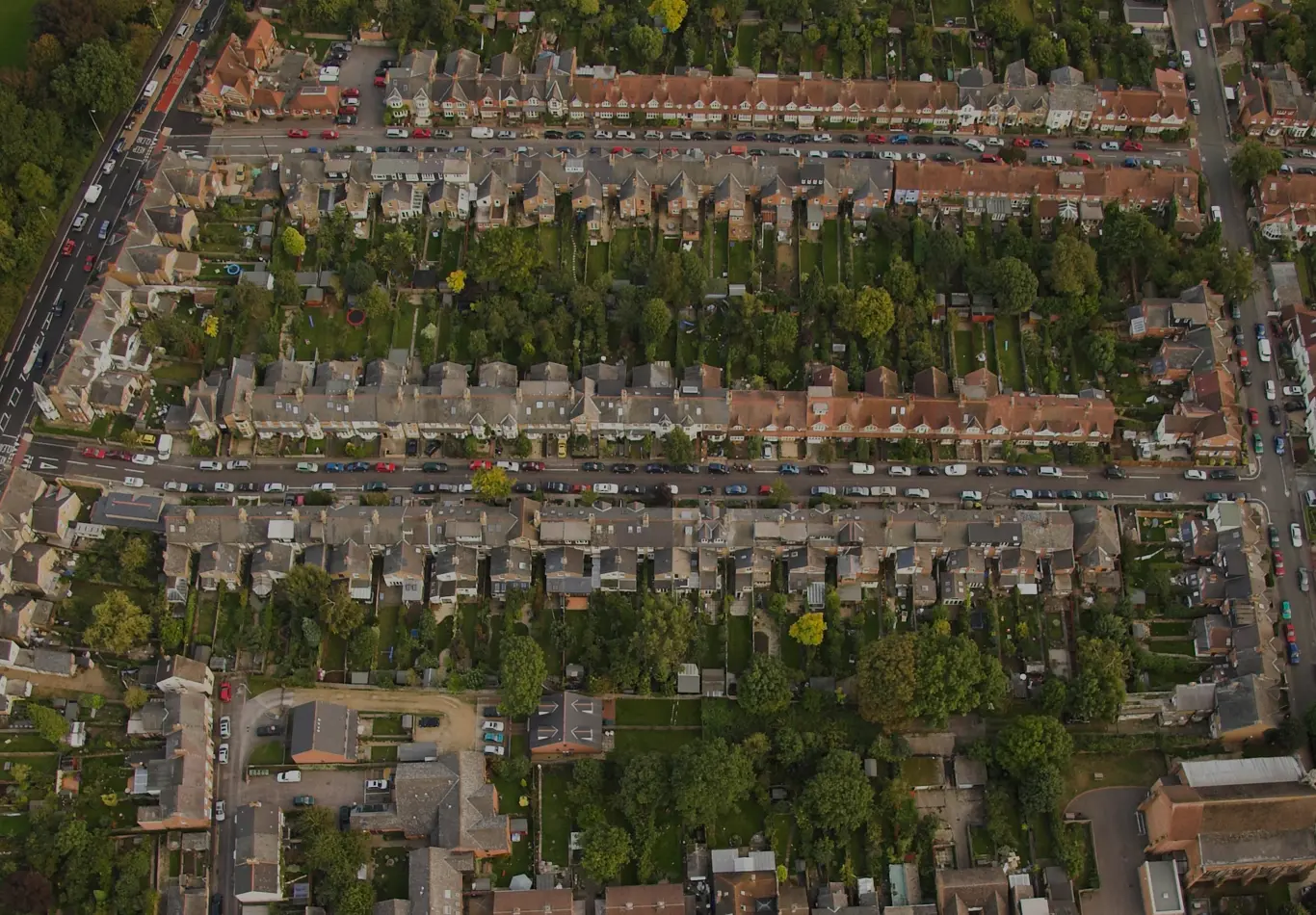 Aerial view of a city block. The streets are crowded with cars. 