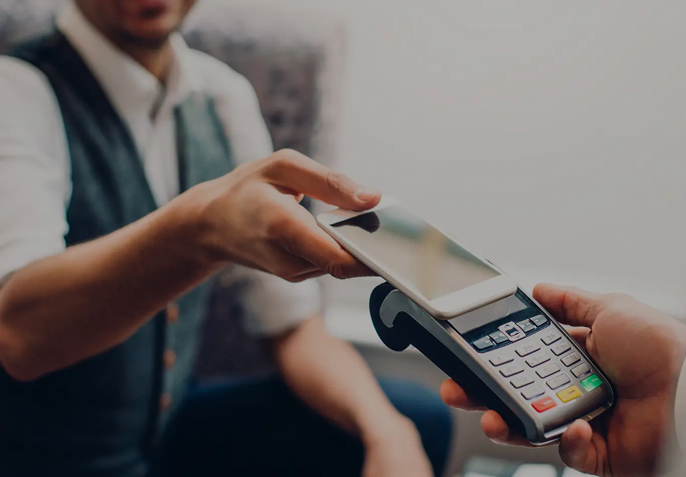 A person is holding their phone to a contactless e reader