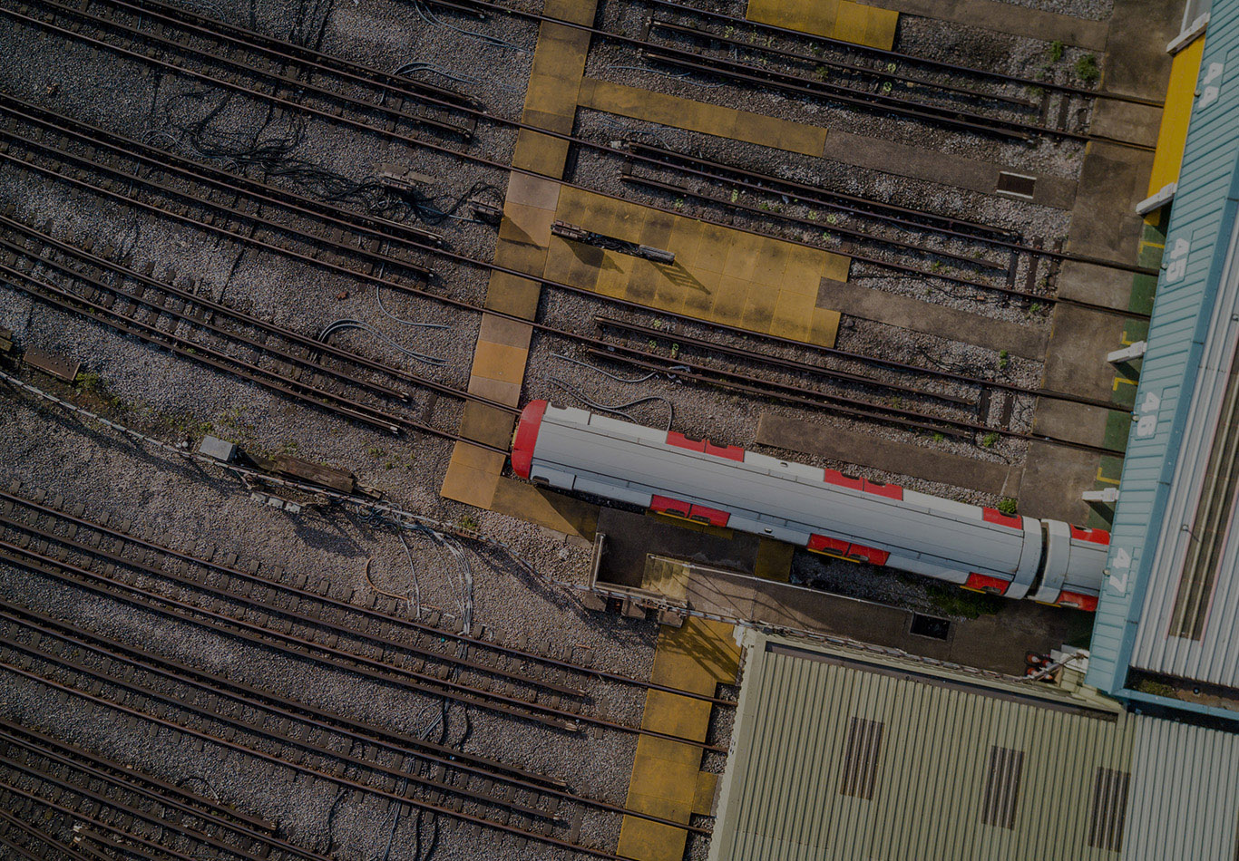 An aerial view of a train depot with one train on the train tracks