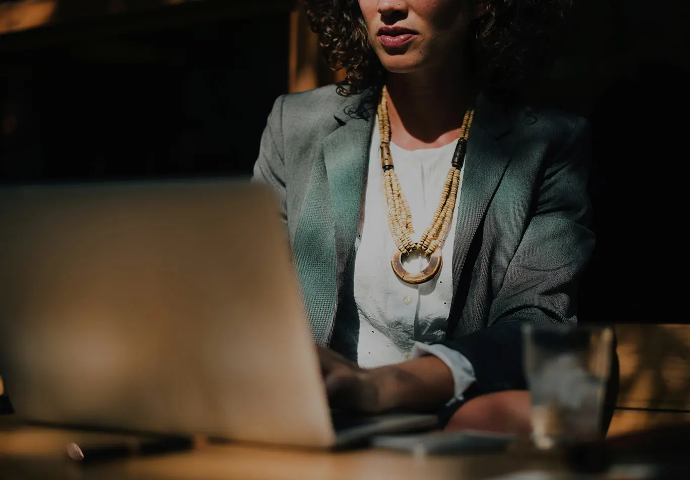 A person is sitting and working on their laptop. 